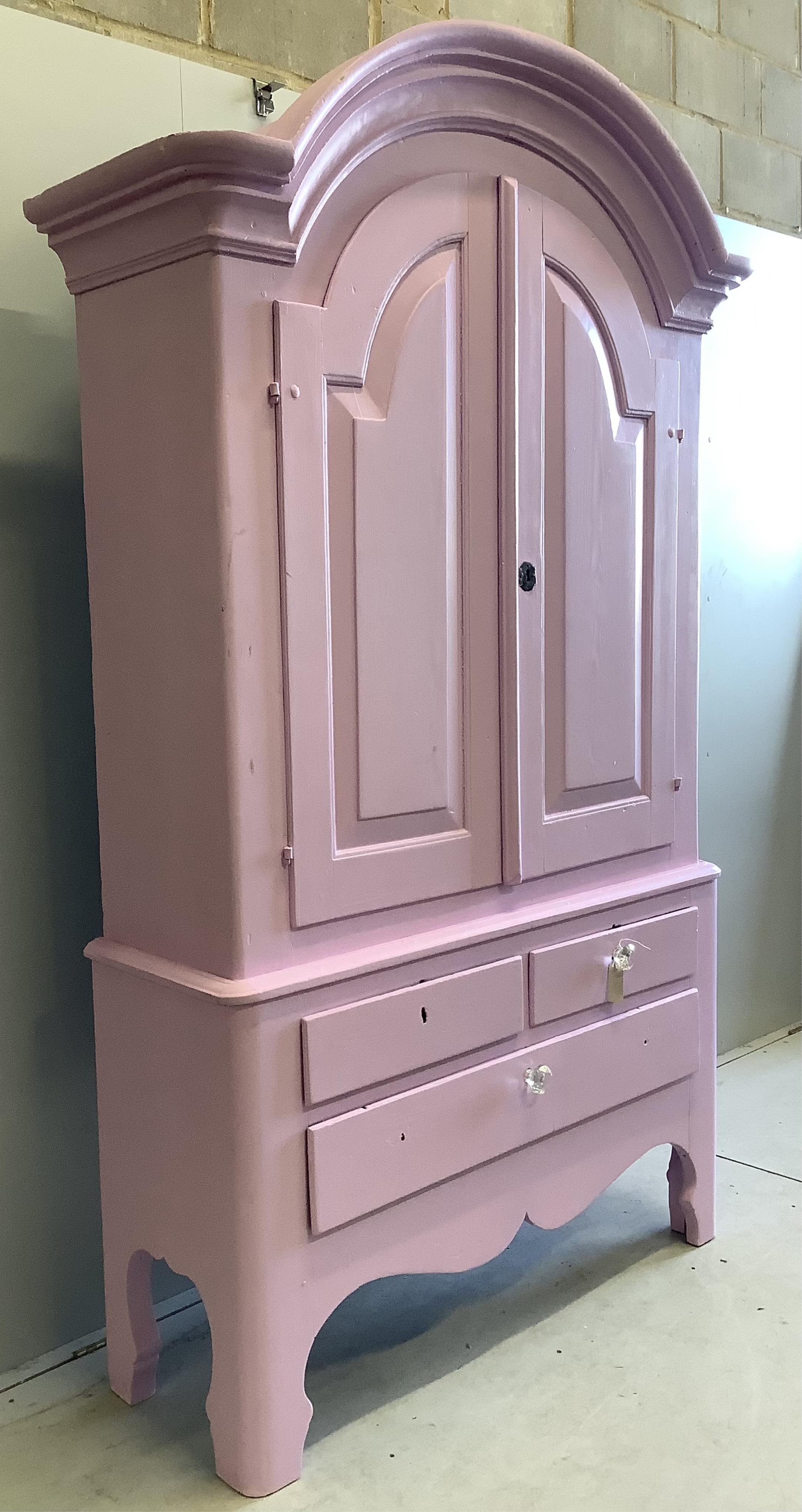 An early 19th century Continental pine armoire, later painted pink, width 136cm, depth 48cm, height 224cm. Condition - fair